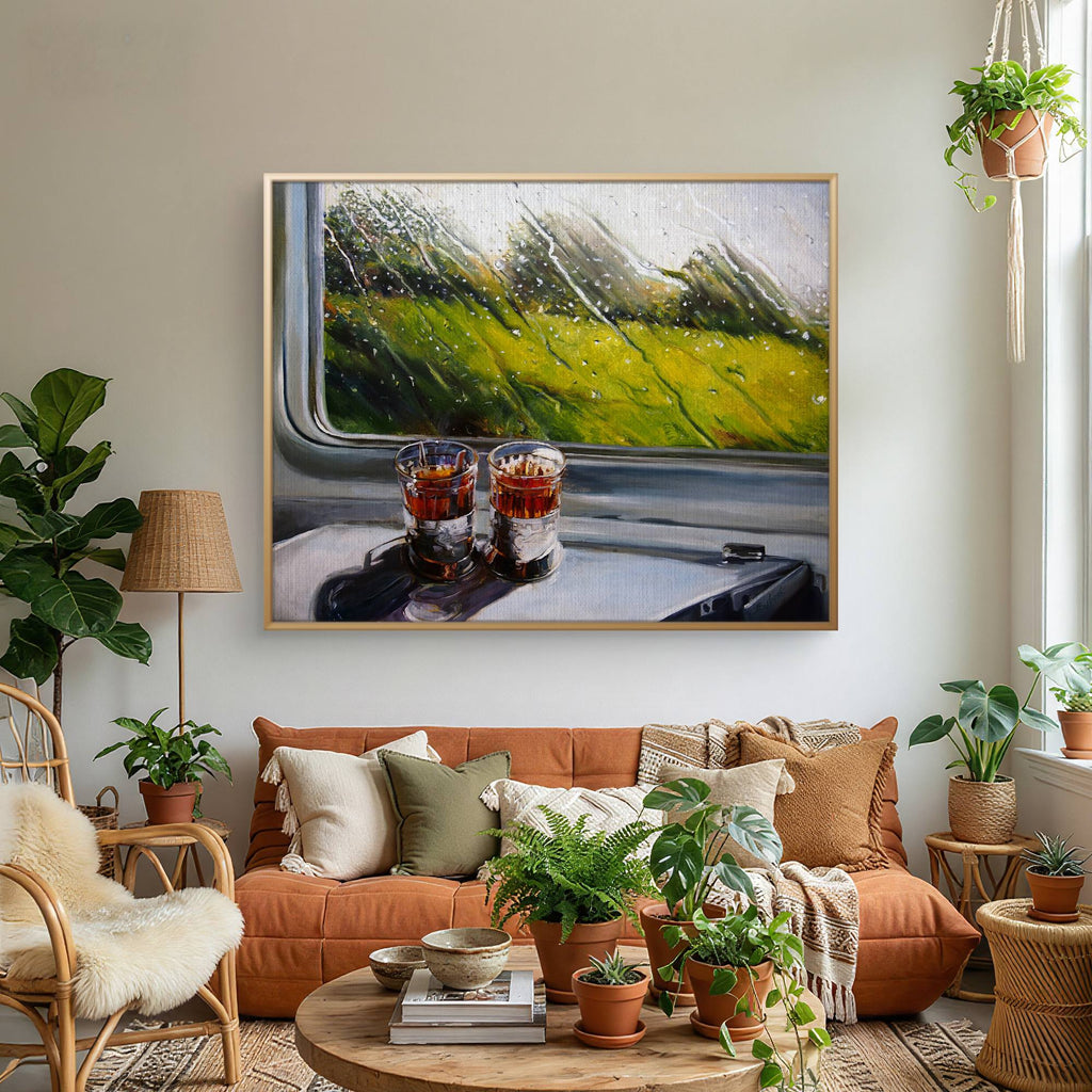 Living room with orange sofa, decorative plants, and a framed painting of a train interior.