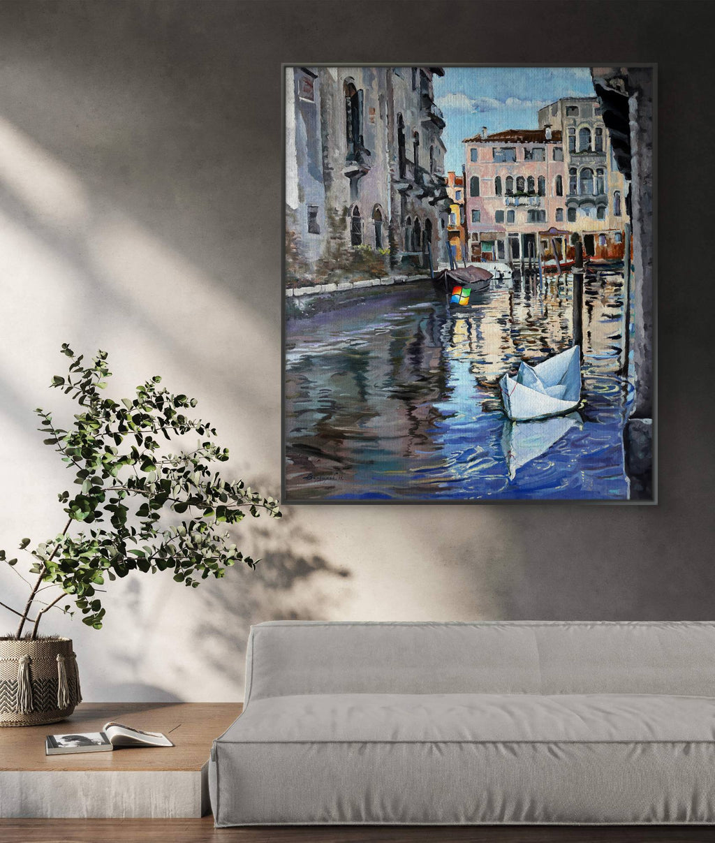 Framed painting of a canal scene with boats in a living room setting.