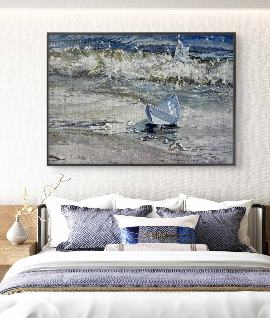 Framed artwork of a boat on water above a bed with matching bedding