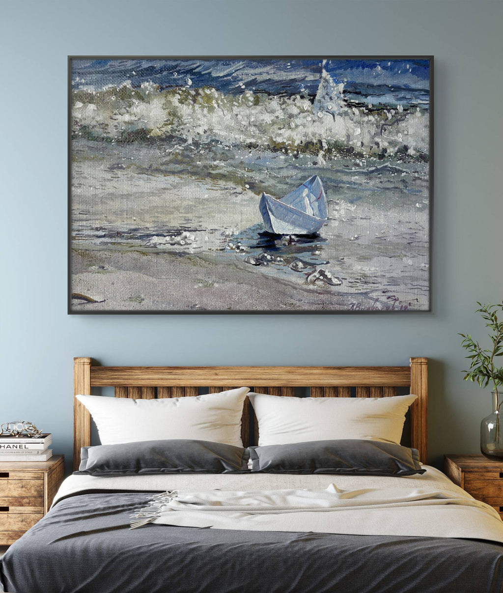 Framed artwork of a boat on water above a bed in a bedroom.