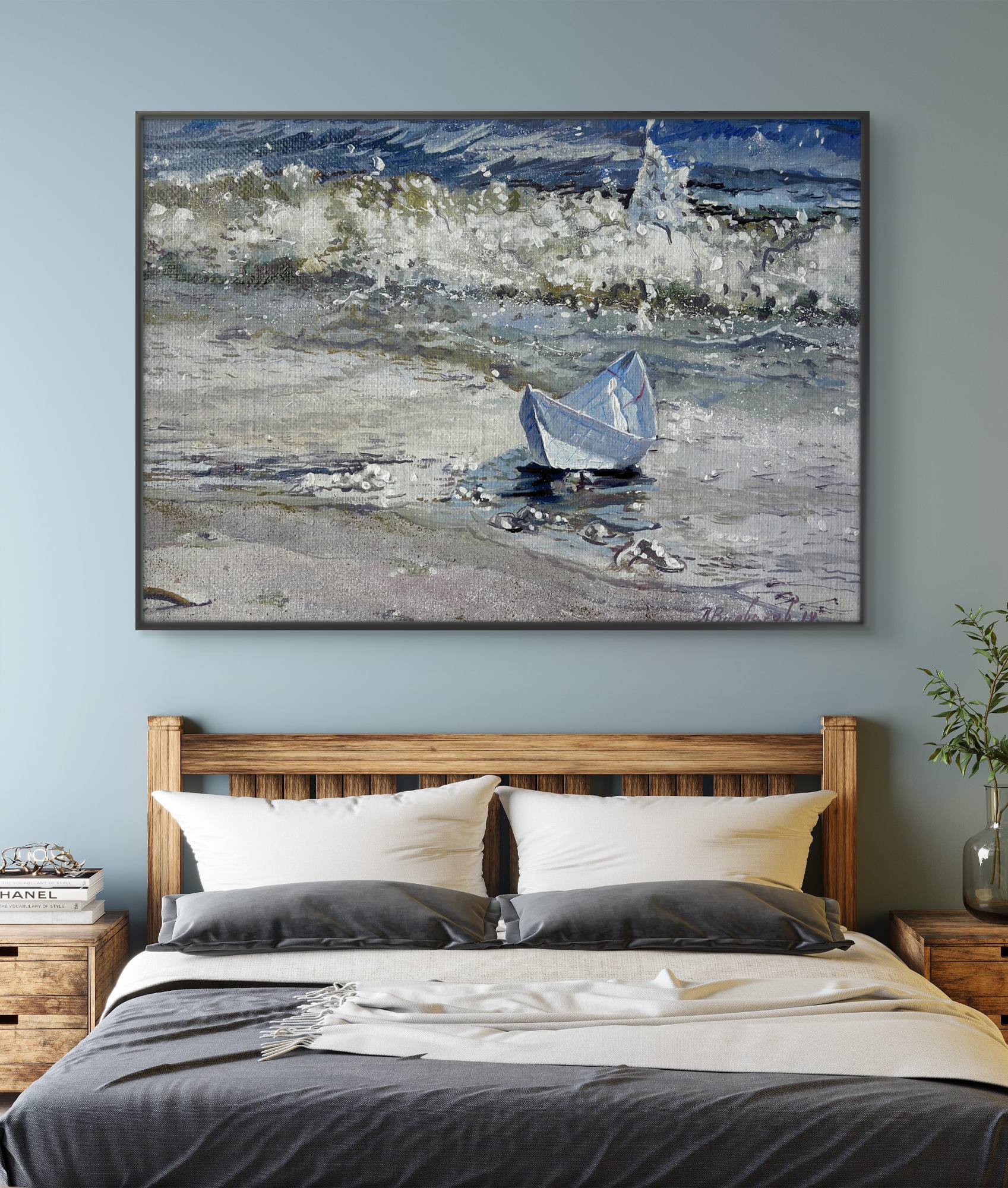 Framed artwork of a boat on water above a bed in a bedroom.