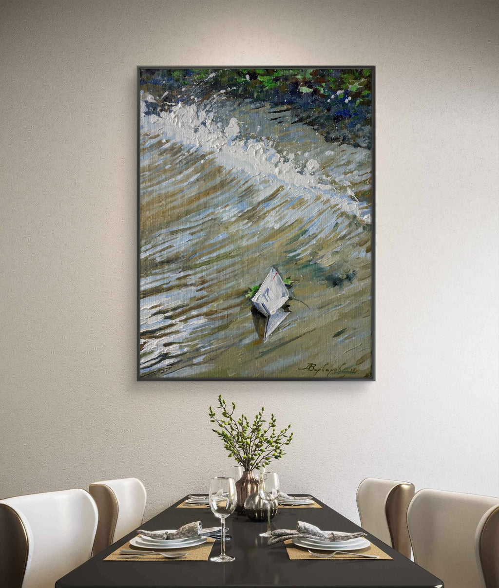 Framed abstract painting on a wall above a dining table with place settings.