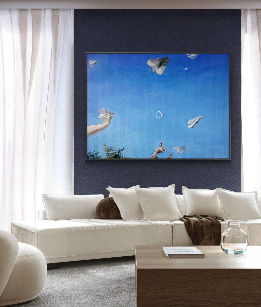 Living room with a large TV displaying an artwork of hands releasing paper airplanes against a blue sky.