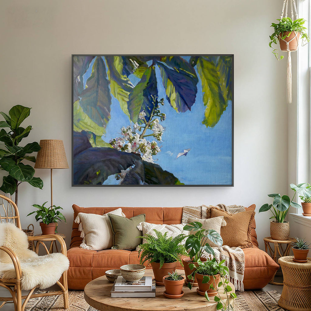 Living room with orange sofa, decorative pillows, and a large framed nature print on the wall.