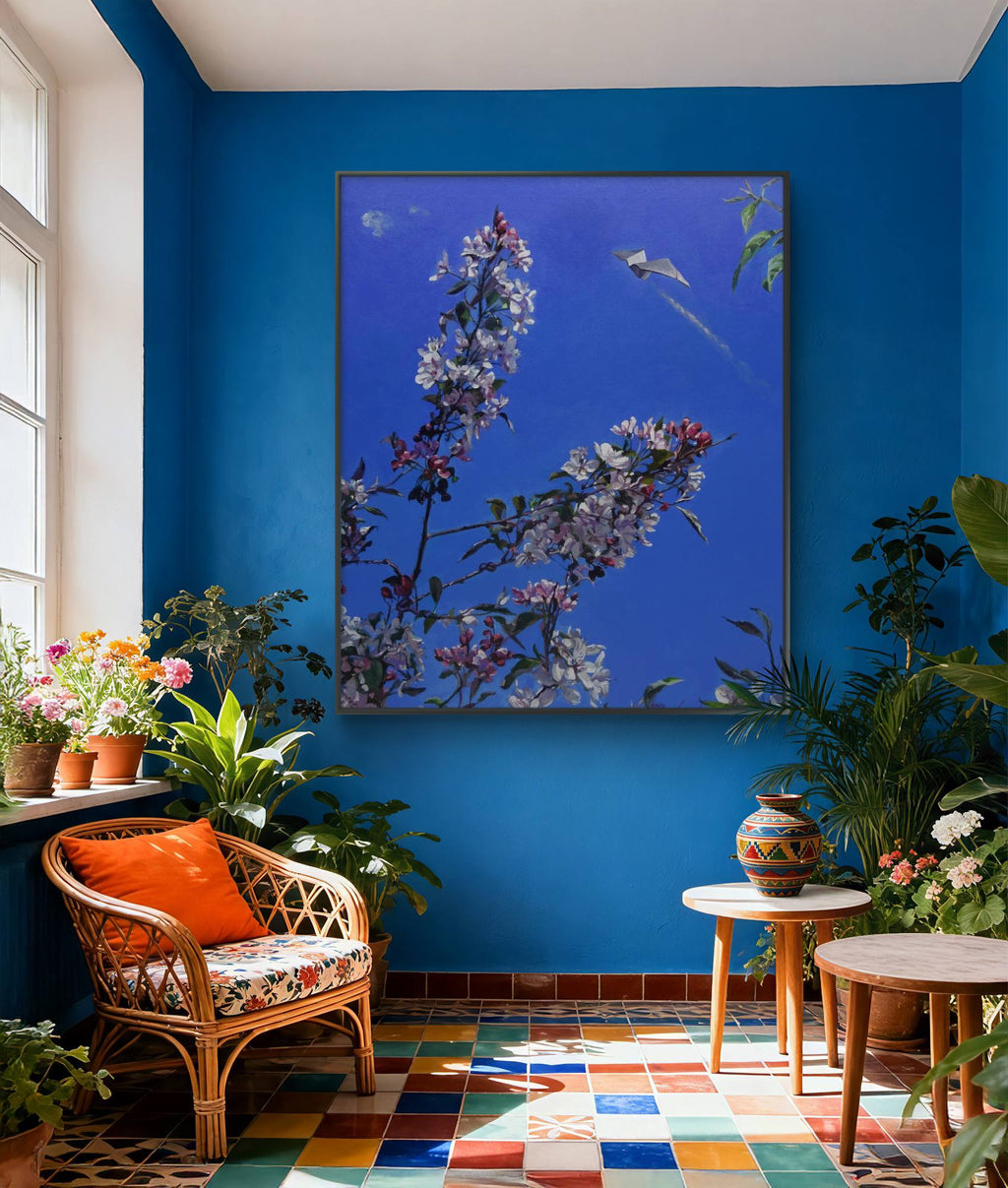 Living room with blue walls, floral artwork, and decorative plants.