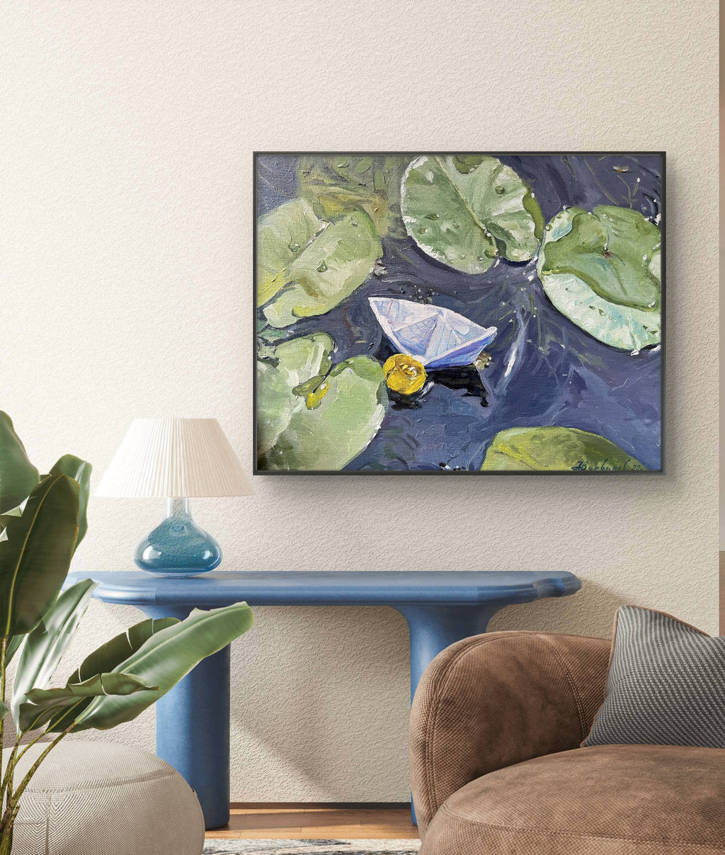 Framed artwork of a boat on water with lily pads in a living room setting.