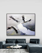 Framed artwork of three birds flying over a landscape in a living room.