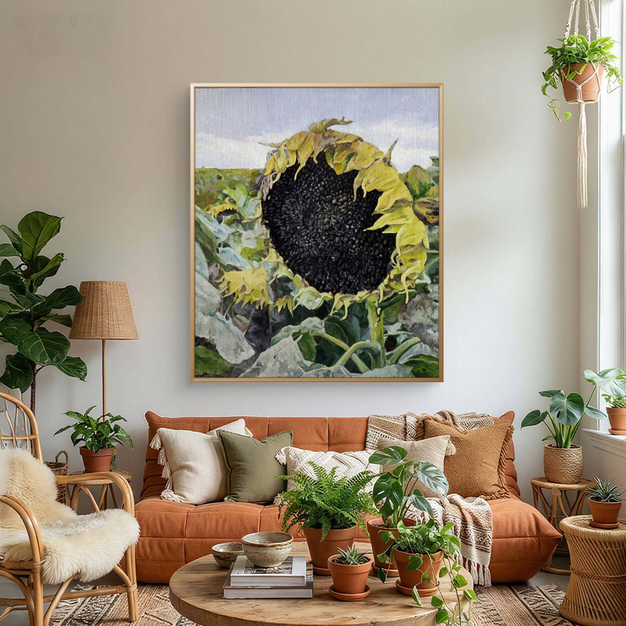 Living room with orange sofa, decorative pillows, and a large sunflower painting on the wall.