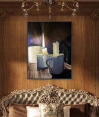 Framed painting of a candle and cup on a wooden wall above an ornate sofa.