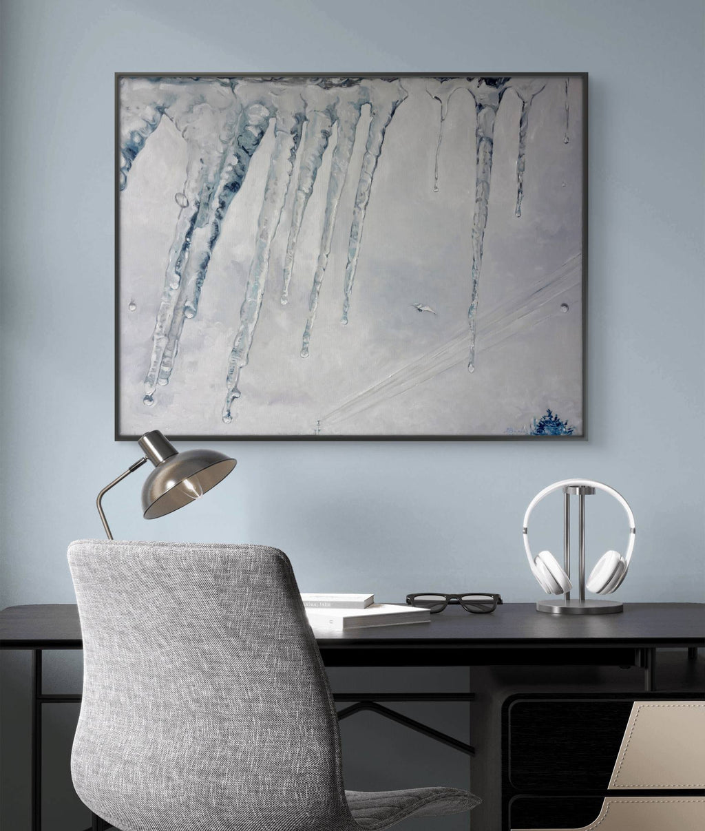Modern office setup with a desk, chair, and abstract artwork on a light blue wall.