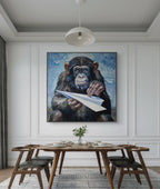 Dining room with a large painting of a chimpanzee holding a paper airplane on the wall.