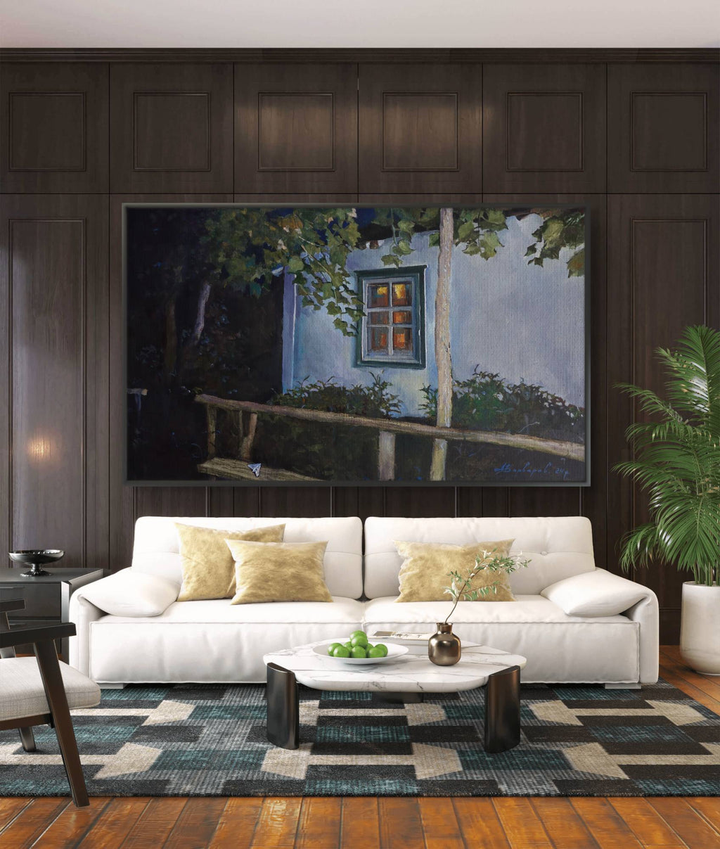 Living room with a white sofa, coffee table, and wall art depicting a window scene.