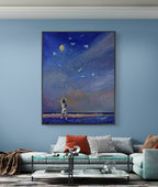 Framed artwork of a child looking at stars on a blue wall above a sofa.