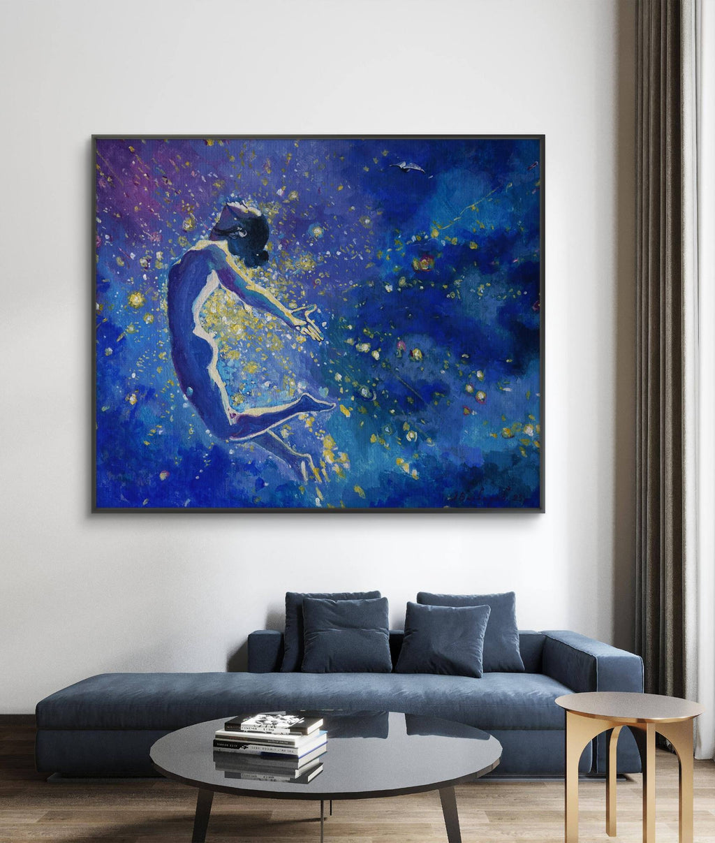 Blue abstract painting of a figure on a wall above a blue sofa in a living room.
