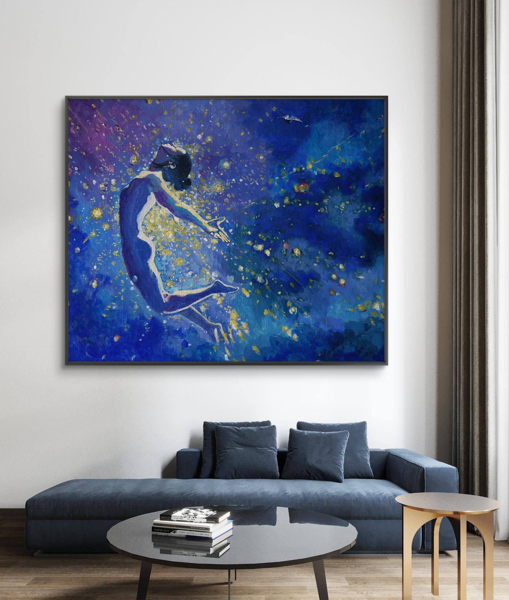 Blue abstract painting of a figure on a wall above a blue sofa in a living room.