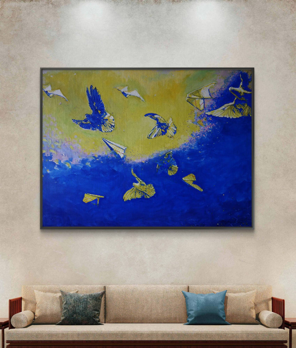 Abstract painting of birds in flight on a wall above a sofa.